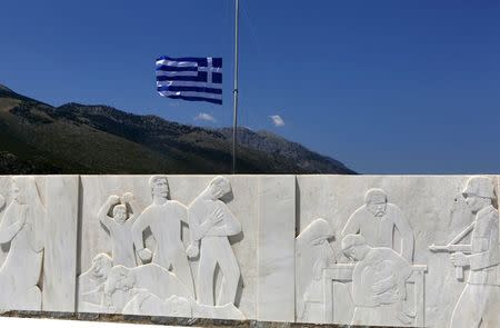 The Greek flag flies half mast on a memorial on the eve of the 68th anniversary of the Distomo massacre committed by the Nazis during World War Two, in the village of Distomo northwest of Athens in this June 9, 2012 file photo. REUTERS/Yannis Behrakis/Files