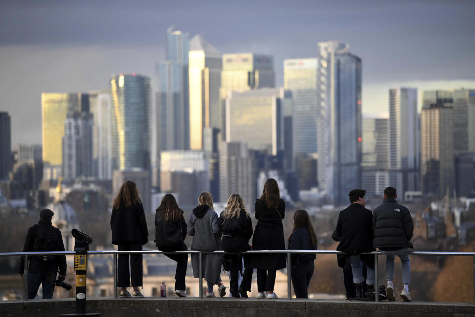 People look out over the city of London, from Greenwich Park in London. Photo: Stefan Rousseau/PA via AP