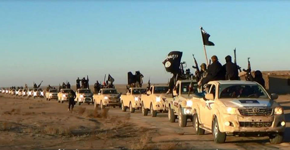 FILE - This file image posted on a militant website on Tuesday, Jan. 7, 2014, which is consistent with AP reporting, shows a convoy of vehicles and fighters from the al-Qaida linked Islamic State of Iraq and the Levant (ISIL) in Iraq's Anbar Province. The ISIL led by Abu Bakr al-Baghdadi is the main driver of destabilizing violence in Iraq and until recently was the main al-Qaida affiliate there. Al-Qaida’s general command formally disavowed the group this week, saying it "is not responsible for its actions." (AP Photo via militant website, File)