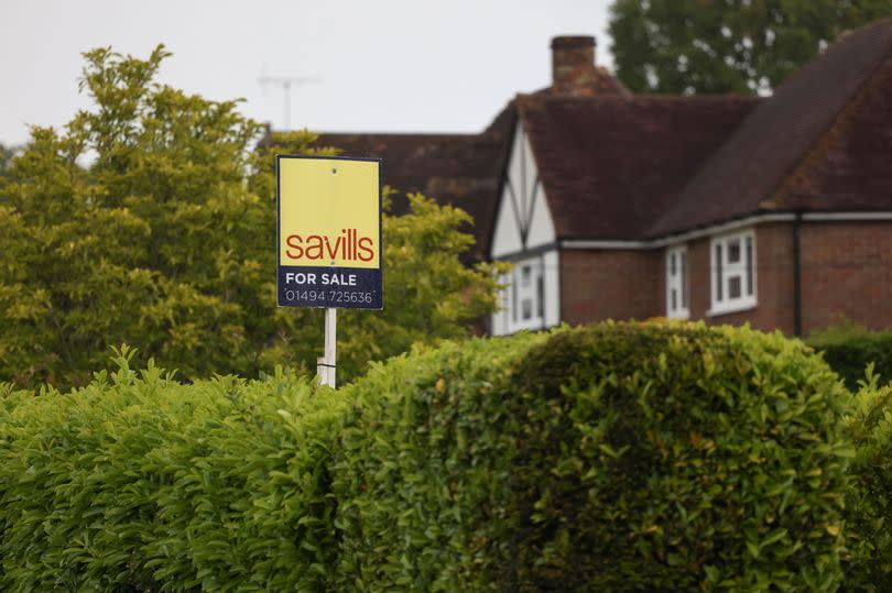 A Savills estate agents 'For Sale' sign outside a residential property in Amersham, UK