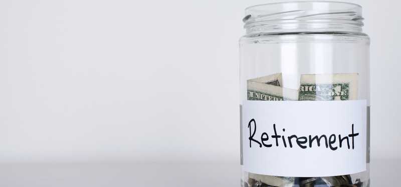 Glass jar with money labeled Retirement.