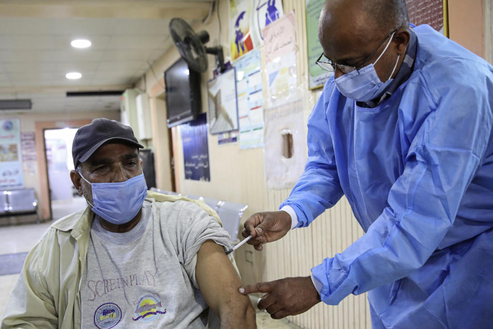 A health worker receives a dose of the Sinopharm coronavirus vaccine at a clinic in Basra, Iraq, Wednesday, March 3, 2021. (AP Photo/Nabil al-Jurani)