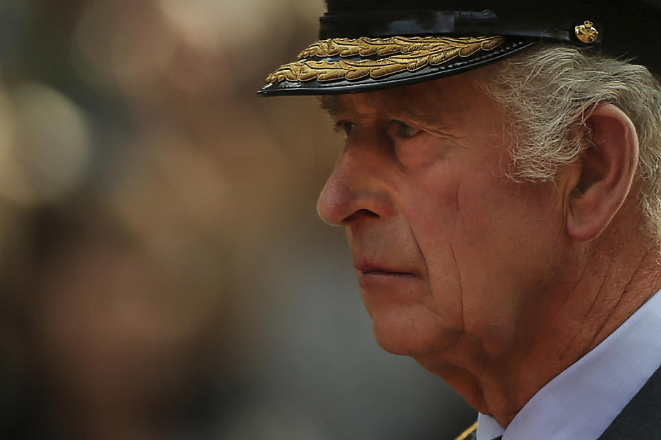Britain's King Charles III walks behind the coffin of Queen Elizabeth II, adorned with a Royal Standard and the Imperial State Crown, pulled by a Gun Carriage of The King's Troop Royal Horse Artillery, during a ceremonial procession of the coffin of Queen Elizabeth II, from Buckingham Palace to Westminster Hall. Wednesday Sept. 14, 2022. Thousands of members of the public are expected to come to pay their final respects at her lying in state. (Isabel Infantes/pool photo via AP)