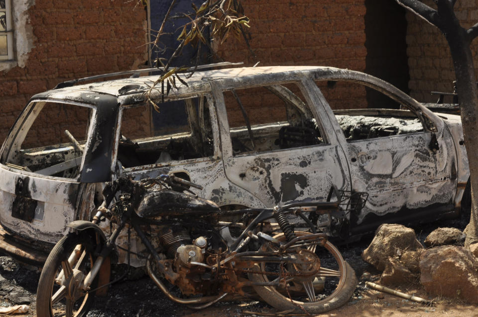 A burnt out car and a motorcycle is seen following an attacked by gunmen in Bokkos, north central Nigeria, Tuesday, Dec. 26, 2023. Nigerian officials and survivors say at least 140 people were killed by gunmen who attacked remote villages in north-central Nigeria's Plateau state in the latest of such mass killings this year blamed on the West African nation's farmer-herder crisis. (AP Photo)