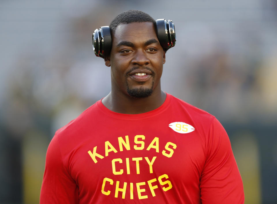 Chris Jones with headphones and a red "Kansas City Chiefs" shirt. 