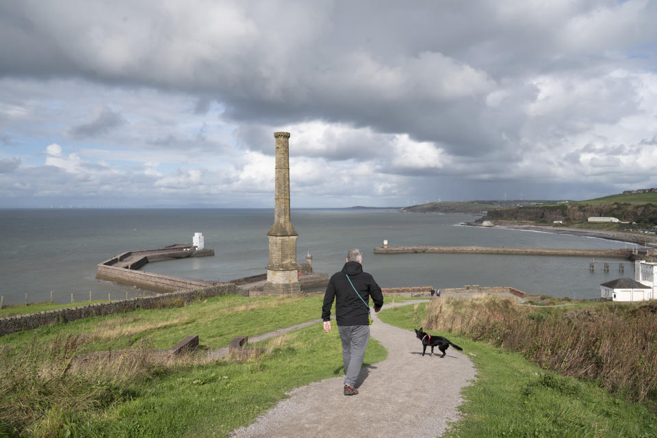 A disused mining ventilation chimney is seen close to the Cumbrian town of Whitehaven near the site of a proposed coal mine in northwest England, Monday, Oct. 4, 2021. (AP Photo/Jon Super)