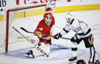 Los Angeles Kings forward Viktor Arvidsson (33) just misses the net as Calgary Flames goalie Jacob Markstrom (25) defends during the second period of an NHL hockey game Saturday, March 30, 2024, in Calgary, Alberta. (Jeff McIntosh/The Canadian Press via AP)