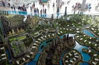 FILE PHOTO: Prospects look at a model of the development at the Country Gardens' Forest City showroom in Johor Bahru