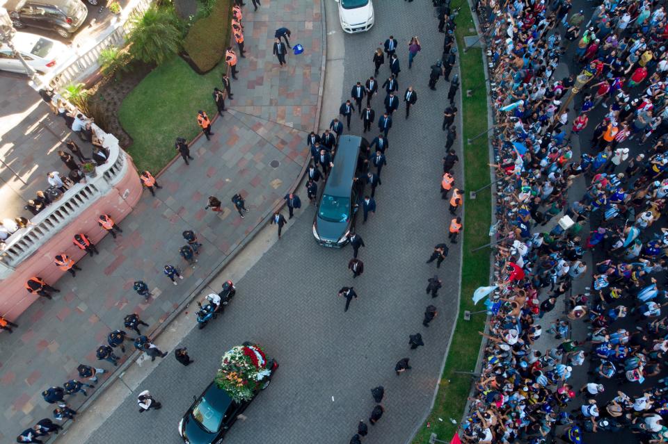 <p>The hearse carrying the casket of Diego Maradona leaves the government house in Buenos Aires</p>AP