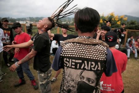 Punk community members mosh during punk music festival in Bandung, Indonesia West Java province, March 23, 2017. Picture taken March 23, 2017. REUTERS/Beawiharta