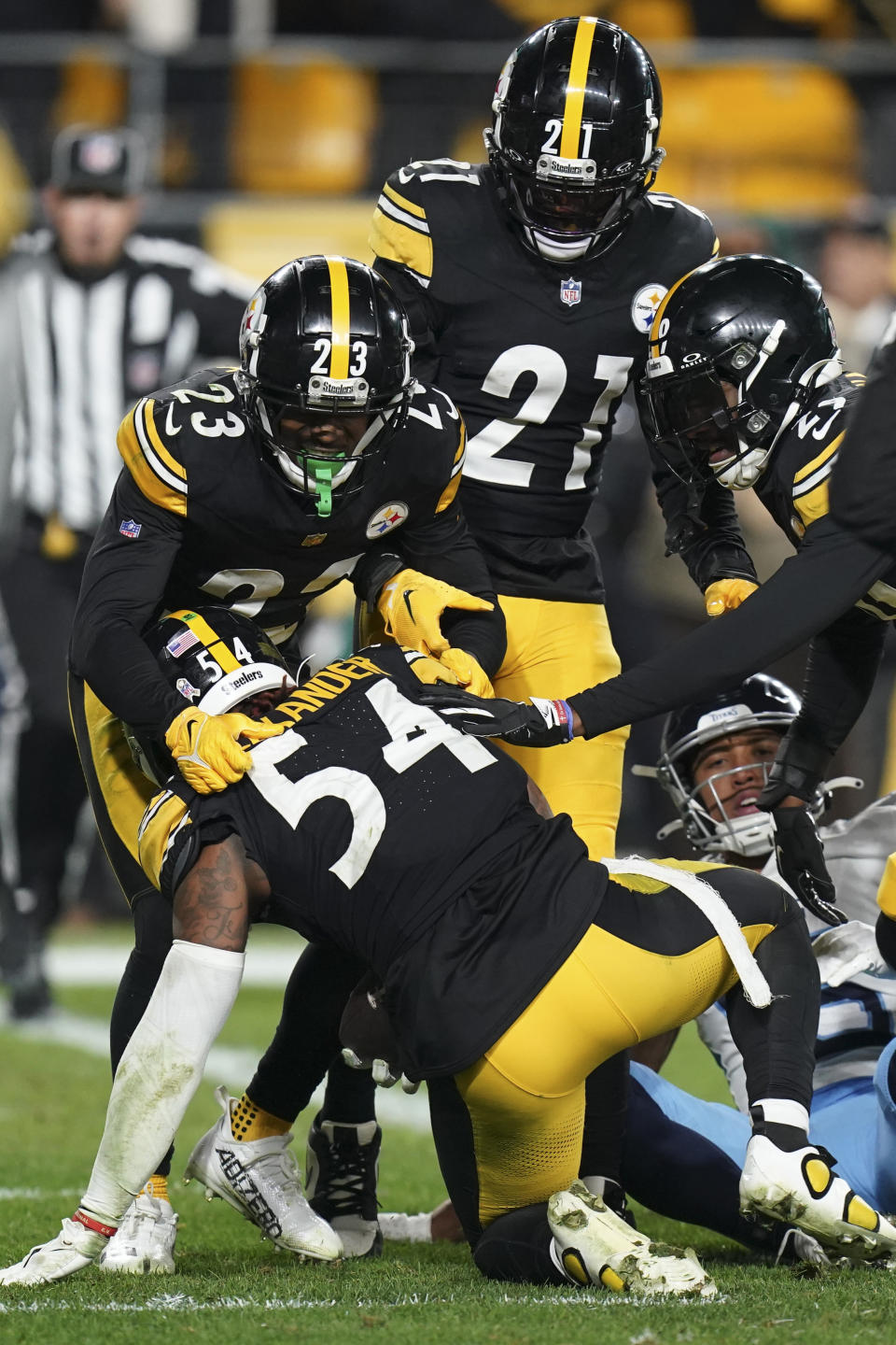 Pittsburgh Steelers linebacker Kwon Alexander (54) is congratulated by teammates Damontae Kazee (23), Darius Rush (21) and Levi Wallace, right, after an interception against the Tennessee Titans during the second half of an NFL football game Thursday, Nov. 2, 2023, in Pittsburgh. (AP Photo/Matt Freed)