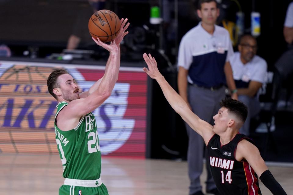 Boston Celtics' Gordon Hayward (20) attempts a shot as Miami Heat's Tyler Herro (14) defends during the second half of an NBA conference final playoff basketball game, Saturday, Sept. 19, 2020, in Lake Buena Vista, Fla. (AP Photo/Mark J. Terrill)