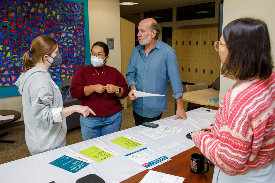 From left, MAPPS project manager Peyton Luiz, Irene Quilantang of the MAPPS Community Advisory Board, project director Mark Lurie and, behind the desk, MAPPS volunteer Batool Benham, a master's degree student in Brown's School of Public Health.