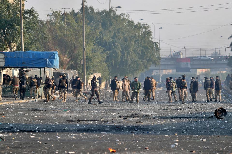 Security forces try to disperse anti-government protesters during clashes in central Baghdad, Iraq, Monday, Jan. 20, 2020. Iraqi security forces also used live rounds, wounding over a dozen protesters, medical and security officials said, in continuing violence as anti-government demonstrators make a push to revive their movement in Baghdad and the southern provinces. (AP Photo/Khalid Mohammed)