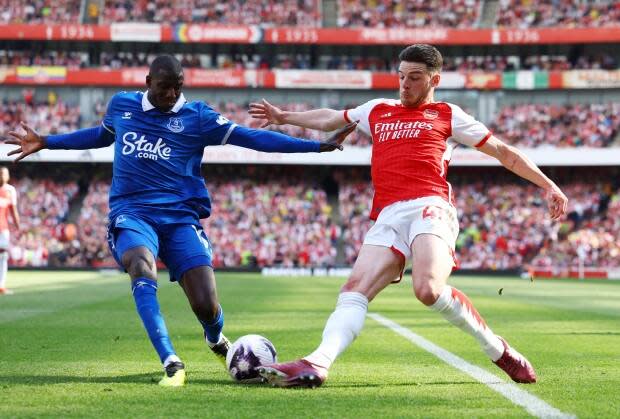 The logo of the Stake gambling brand is seen on the front of the jersey of Everton FC player Aboulaye Doucouré, left, during a English Premier League soccer game against Arsenal FC last month. 