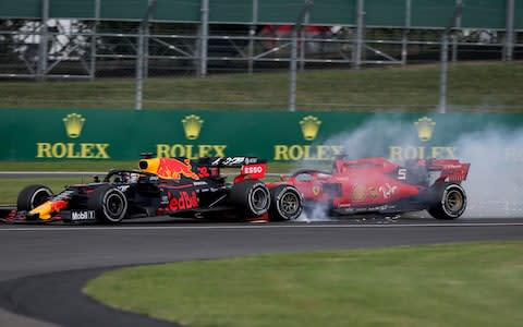 Max Verstappen of the Netherlands driving the (33) Aston Martin Red Bull Racing RB15 and Sebastian Vettel of Germany driving the (5) Scuderia Ferrari SF90 crash during the F1 Grand Prix of Great Britain at Silverstone on July 14, 2019 in Northampton, England.  - Credit: Getty Images Europe