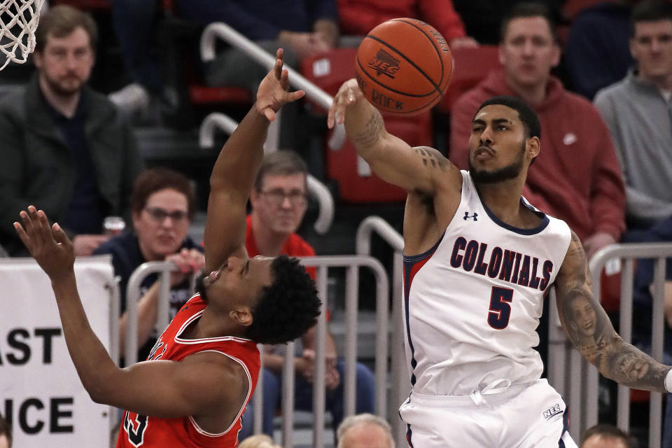 Robert Morris' AJ Bramah (5) blocks a shot by St. Francis' Keith Braxton during the first half of an NCAA college basketball game for the Northeast Conference men's tournament championship in Pittsburgh, Tuesday, March 10, 2020. (AP Photo/Gene J. Puskar)