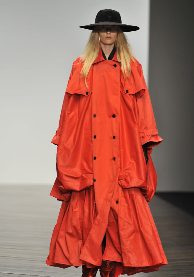 <b>London Fashion Week AW13: KTZ<br><br></b>The KTZ show hit the runway in typical off-the-wall fashion, with this model showing off a tiered, baggy orange rain mac. Interesting.<br><br>©Rex