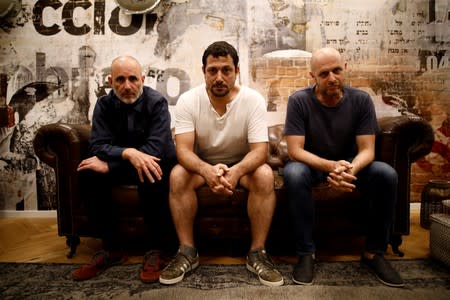 Co-creators of HBO series "Our Boys", Hagai Levi, Tawfik Abu Wael, and Joseph Cedar, pose for a picture during their interview with Reuters in Tel Aviv