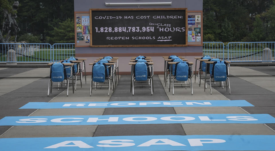 UNICEF unveiled its art installation 'No Time to Lose,' featuring a counting clock on a blackboard of an empty classroom, displaying in real-time the 1.8 trillion hours – and counting – of lost in-person learning around the world since the pandemic's onset, Friday Sept. 17, 2021 at U.N. headquarters. The installation will be on display throughout the course of the 76th session of the United Nations General Assembly (UNGA). (AP Photo/Bebeto Matthews)