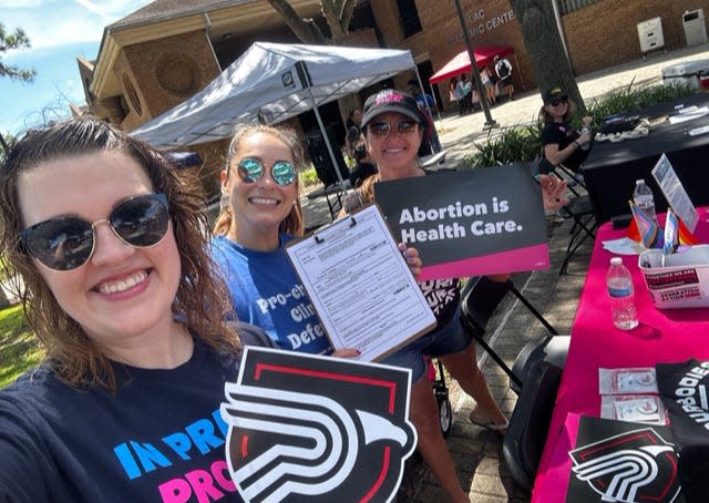 Taylor Aguilera, left, stands with other advocates during a signature drive in October at Polk State College in Lakeland. Aguilera is interim organizing director for Floridians Protecting Freedom.