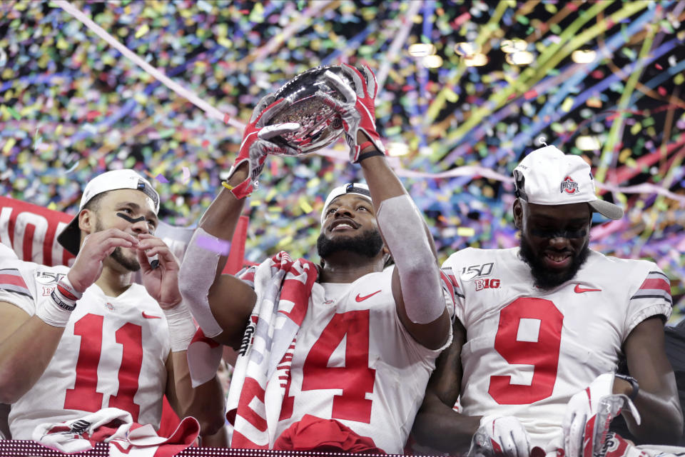 Ohio State wide receiver K.J. Hill (14) holds the trophy following the team's 34=21 win over Wisconsin in the Big Ten championship NCAA college football game, early Sunday, Dec. 8, 2019, in Indianapolis. (AP Photo/Michael Conroy)