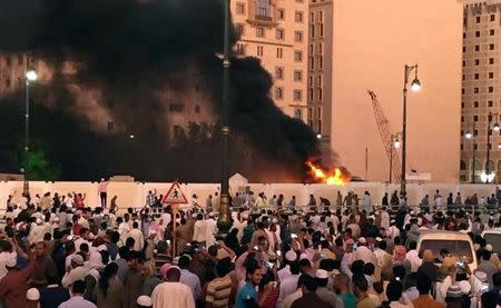 Muslim worshippers gather after a suicide bomber detonated a device near the security headquarters of the Prophet's Mosque in Medina, Saudi Arabia, July 4, 2016. REUTERS/Handout