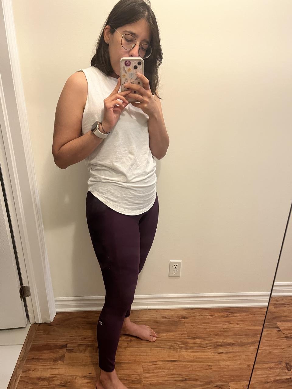 Wearing Alo Yoga's 7/8 High-Waist Airlift Legging in Dark Plum. 