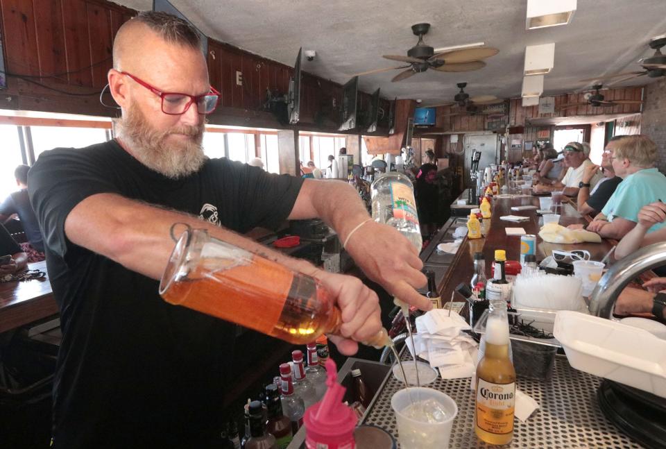 Elliott Schaafsma, bartender and manager at The Breakers Restaurant in New Smyrna Beach, mixes a drink, Monday, May 1, 2023.