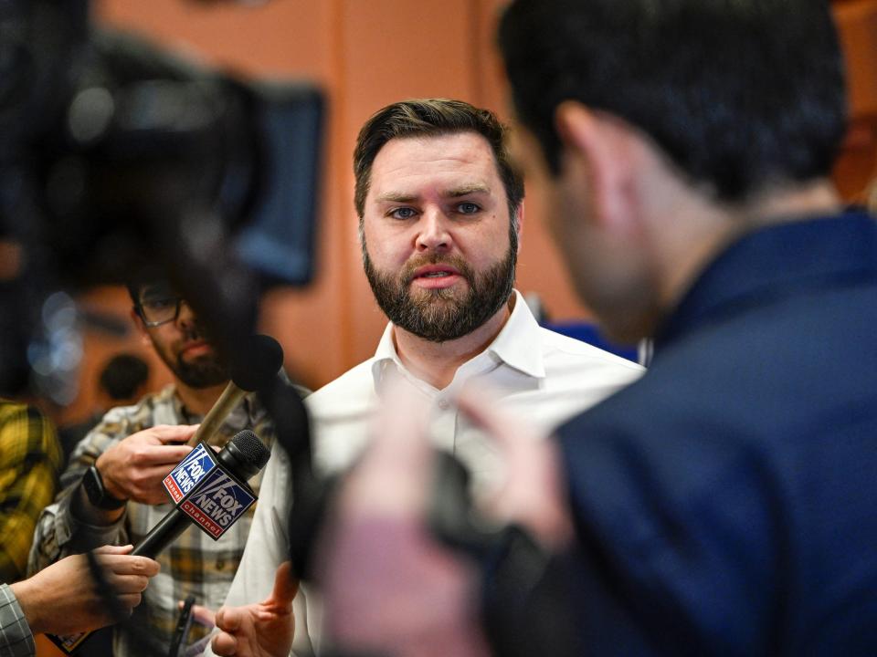 JD Vance talks with members of the media after speaking at a campaign stop