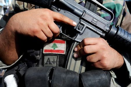 A Lebanese army soldier holds his weapon after being deployed to tighten security, following clashes between Lebanese soldiers and Islamist gunmen in Tripoli, northern Lebanon October 27, 2014. REUTERS/Mohamed Azakir