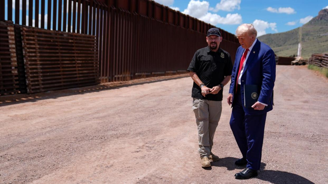 PHOTO: Republican presidential nominee former President Donald Trump listens to Paul Perez, president of the National Border Patrol Council, as he tours of the southern border with Mexico, Aug. 22, 2024, in Sierra Vista, Ariz.  (Evan Vucci/AP)