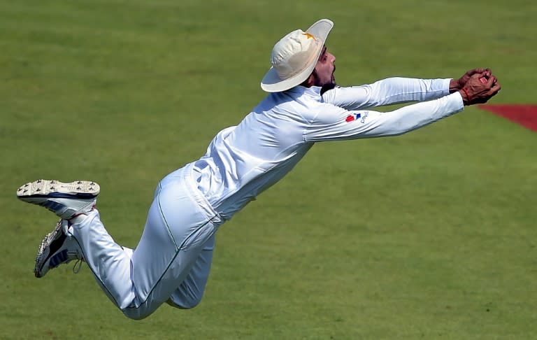 Pakistan's Mohammad Amir takes a diving catch to dismiss West Indies batsman Darren Bravo in Sharjah on October 31, 2016