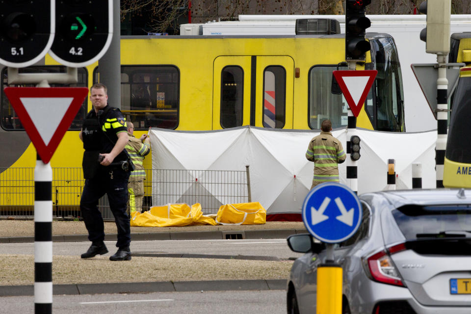 FILE - In this Monday, March 18, 2019 file photo, rescue workers at the scene following a shooting in Utrecht, Netherlands. Dutch prosecutors say they have a “strong indication” that a man accused of fatally shooting four passengers on a tram in the central city of Utrecht in March had a “terrorist motive.” Prosecutors say that 37-year-old suspect Gokmen Tanis left a handwritten letter in a getaway car that said in Dutch: “I’m doing this for my religion, you kill Muslims and you want to take our religion away from us, but you won’t succeed.” (AP Photo/Peter Dejong, File)