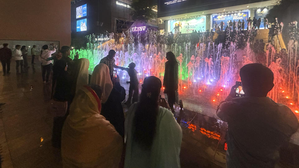 People take selfies in front of a musical fountain in a shopping mall, in Patna, in the Indian state of Bihar, on May 13, 2024. Even as India's millionaires multiply, nearly 90% of its 1.4 billion population earns less than the average annual income of around $2,770, according to a World Inequality Lab study. The richest 1% own more than 40% of the country's wealth, while the bottom 50% of earners own only 3%. (AP Photo/Manish Swarup)