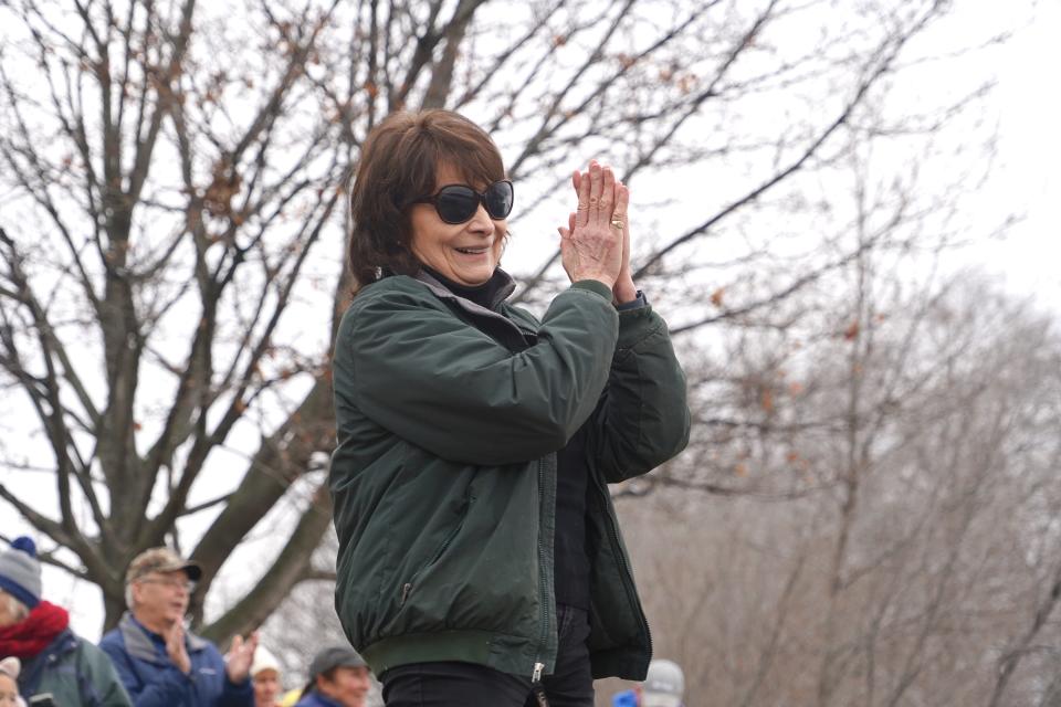 Marge Gibson, executive director of Raptor Education Group, Inc. (REGI) of Antigo, and observers clap Jan. 6 at the successful release of a bald eagle along the Wisconsin River in Prairie du Sac. The eagle had been rehabilitated at REGI after being admitted in November with a broken wing.