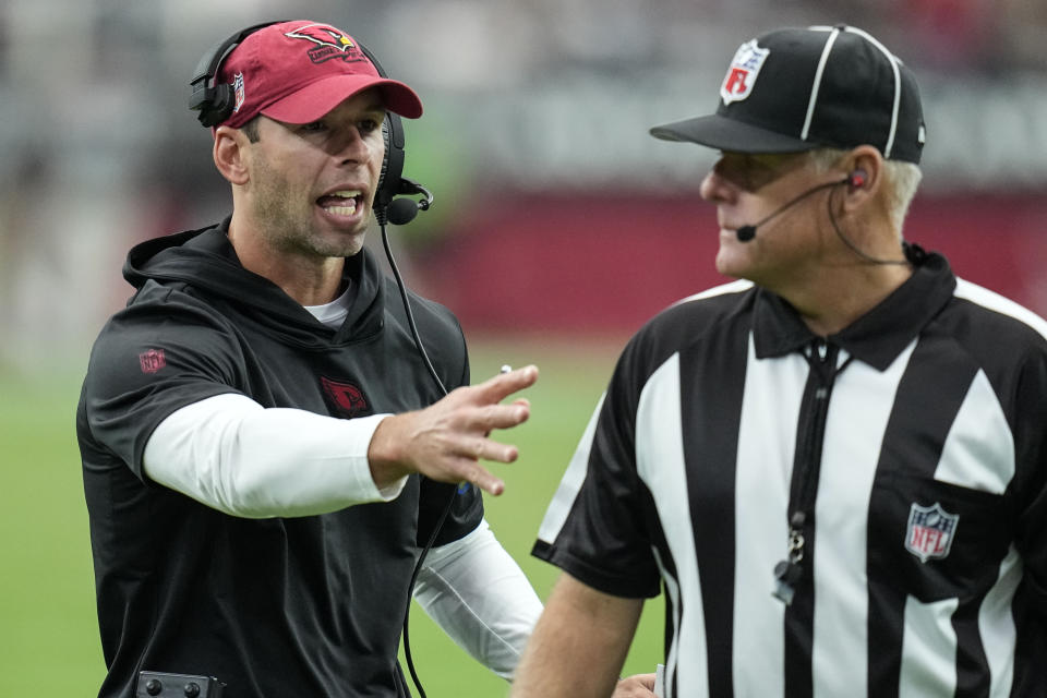 Arizona Cardinals head coach Jonathan Gannon speaks with an official during the first half of an NFL football game against the Dallas Cowboys, Sunday, Sept. 24, 2023, in Glendale, Ariz. (AP Photo/Ross D. Franklin)