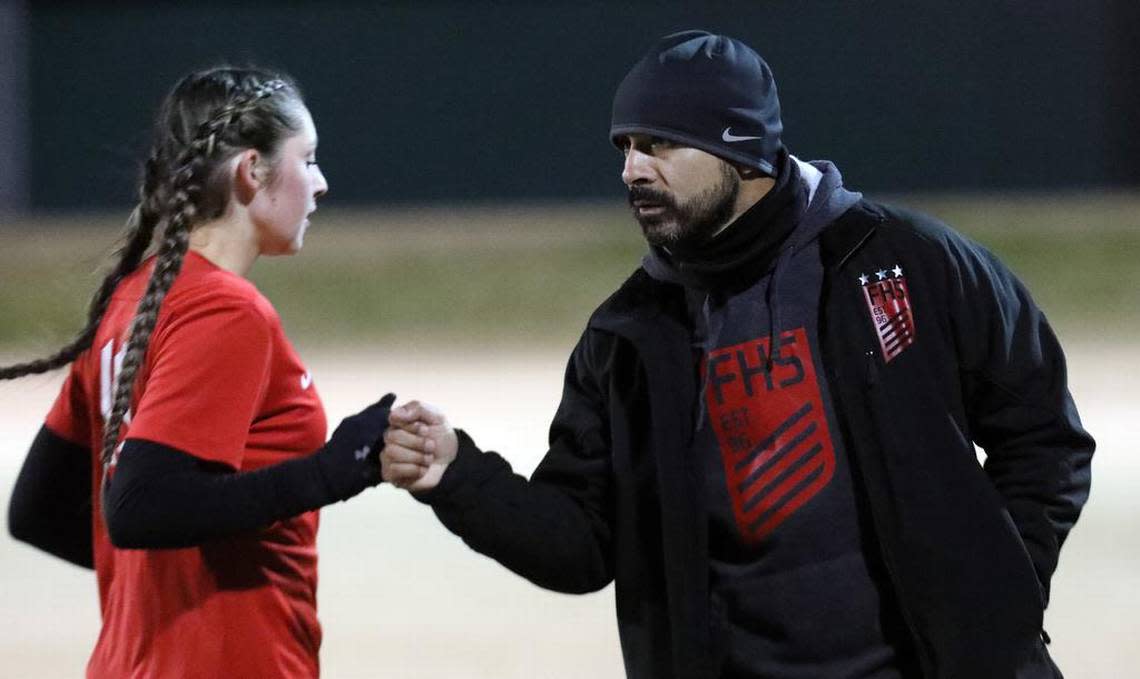 Fowler High head coach Richard Gonzales fist-bumps a player during a CIF Central Section Division IV girls soccer match on Feb. 15, 2023 at Fowler High. Second-seeded Fowler defeated Reedley High, 5-0.