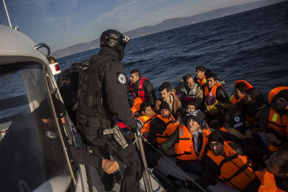 FILE - Members of the Frontex, European Border Protection Agency, from Portugal rescue 56 people, who were lost in an open sea as they try to approach on a dinghy the Greek island of Lesbos, on Dec. 8, 2015. A much-anticipated report made public Thursday Oct. 13, 2022 by the European Union's anti-fraud watchdog into the alleged involvement of the EU border agency Frontex in the illegal pushbacks of migrants from Greece to Turkey has concluded that agency employees were involved in covering up such incidents in violation of peoples' "fundamental rights." (AP Photo/Santi Palacios, File)