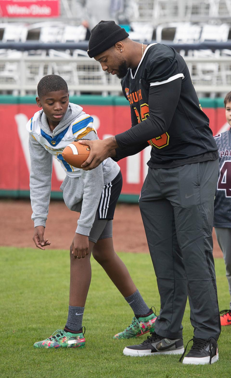 University of Alabam’s Anfernee Jennings draws up a passing play for Zion Milhouse during a stop in Pensacola by the Senior Bowl Caravan on Friday, Jan.24, 2020. Jennings is a member of the 2020 Senior Bowl South squad team.