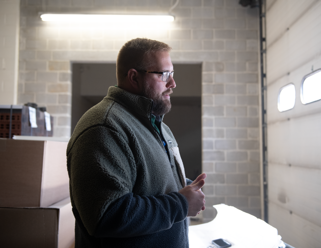 Portage County Emergency Management Director Ryan Shackleford stands between two large climate-controlled storage rooms in the agency's storage facility.