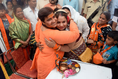 FILE PHOTO: Pragya Thakur, a Bharatiya Janata Party (BJP) candidate in the parliamentary election, hugs a party supporter during her election campaign meeting in Bhopal, India, April 30, 2019. Picture taken April 30, 2019. REUTERS/Raj Patidar/File Photo