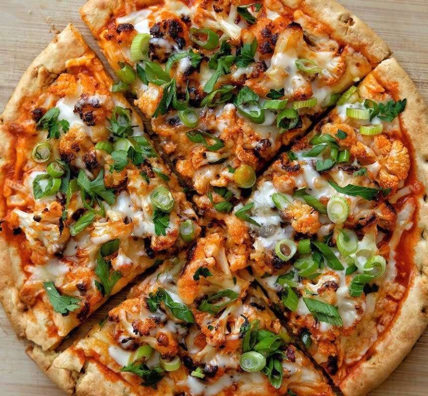 <p>Carina Wolff</p><p>A chickpea pizza topped with buffalo cauliflower, mozzarella, green onion, parsley and ranch.</p><p><strong>Get the recipe: <a href="https://parade.com/1125492/kelli-acciardo/buffalo-cauliflower-pizza-recipe/" rel="nofollow noopener" target="_blank" data-ylk="slk:Buffalo Cauliflower Pizza;elm:context_link;itc:0;sec:content-canvas" class="link rapid-noclick-resp">Buffalo Cauliflower Pizza</a></strong></p>