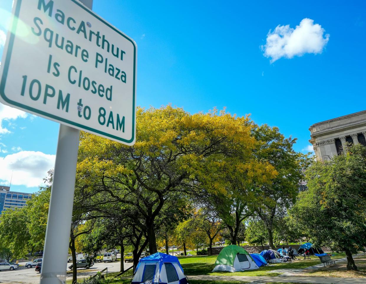 Tents occupied by the homeless are seen Friday, Oct. 7, 2022, at MacArthur Square in Milwaukee. The increase in tents over time is starting to cause an issue. Street Angels, a nonprofit group, hands out tents, sleeping bags and coolers to the homeless, which some say encourages the behavior and prevents them from wanting to leave.