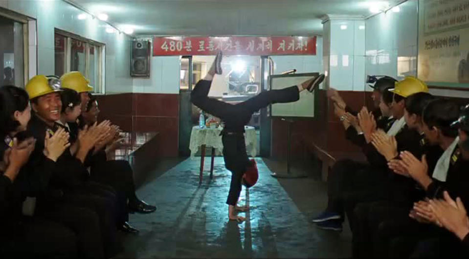 In this image made out of film "Comrade Kim Goes Flying" released by Another Dimension of An Idea/Koryo Group, Comrade Kim Yong Mi played by Han Jong Sim, center, receives applause from her coal mine comrades for her acrobatic performance. It's a classic tale of a small town girl who follows her dreams to the big city. But in this case, the girl is a North Korean coal miner, the big city is Pyongyang and her dream is to become a high-flying trapeze artist. “Comrade Kim Goes Flying,” a collaboration between a North Korean director and two European filmmakers, makes its world premiere Saturday, Sept. 8, 2012 at the Toronto International Film Festival before it heads to Pyongyang later this month for its North Korean debut. (AP Photo/Courtesy of Another Dimension of An Idea/Koryo Group) EDITORIAL USE ONLY