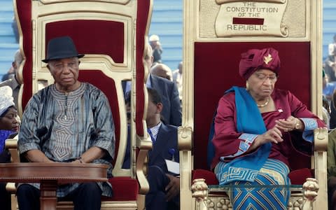 Liberia's former President Ellen Johnson Sirleaf (R) and her Vice President Joseph Nyumah Boakai attend the ceremony - Credit: THIERRY GOUEGNON/ REUTERS