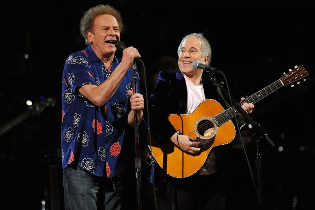 <p>Stephen Lovekin/Getty</p> Art Garfunkel and Paul Simon performing together in 2009