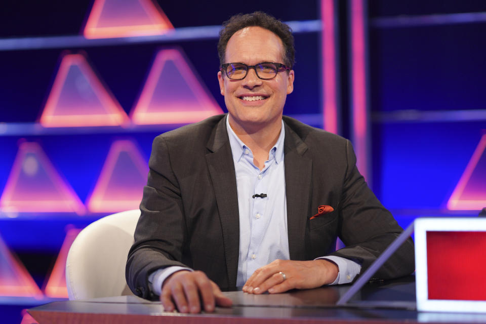 diedrich bader in a light blue shirt and gray blazer and glasses