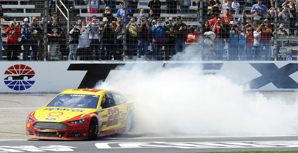 Joey Logano (22) burns his tires after winning the NASCAR Sprint Cup series auto race at Texas Motor Speedway, Monday, April 7, 2014, in Fort Worth, Texas. (AP Photo/Ralph Lauer)