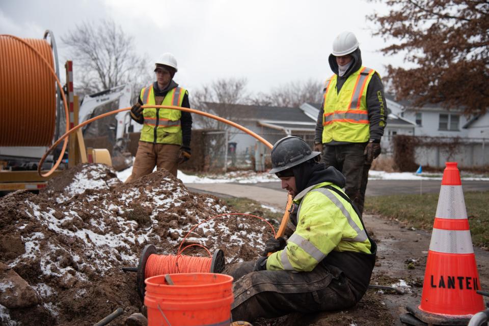 In this 2019 file photo, workers with Greenlight Networks, a high-speed fiber optic internet provider in Rochester, begin installation in Greece, a Rochester suburb. Several workers dug through cold, muddy ground along Dorsetwood Drive on Tuesday, Feb. 26, 2019, to find current underground utilities.